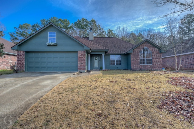 view of front of house with a garage and a front lawn