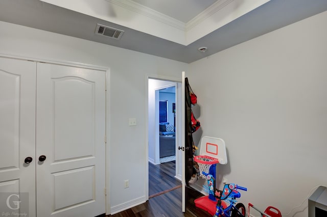 game room with dark hardwood / wood-style flooring and crown molding