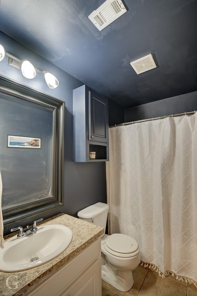 bathroom with tile patterned floors, toilet, and vanity