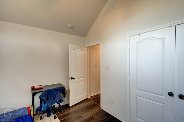 bedroom with lofted ceiling and dark hardwood / wood-style flooring