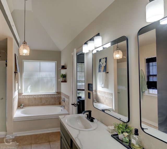 bathroom featuring vanity, vaulted ceiling, a washtub, and tile patterned floors