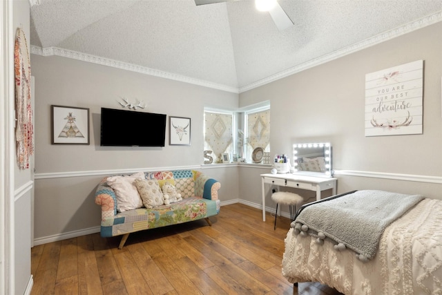 bedroom featuring crown molding, vaulted ceiling, a textured ceiling, ceiling fan, and hardwood / wood-style floors