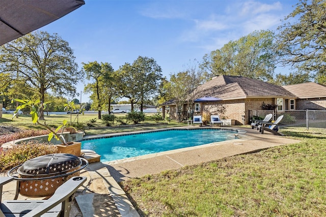 view of pool featuring a patio, a yard, and an outdoor fire pit