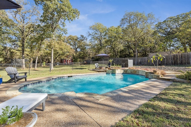 view of pool with a lawn and a patio