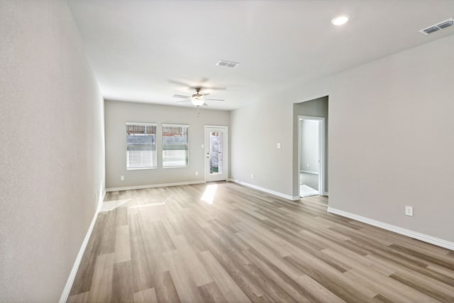 empty room featuring ceiling fan and light hardwood / wood-style flooring