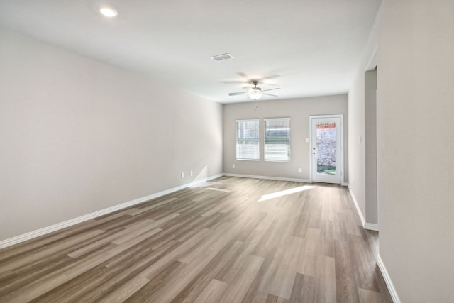 unfurnished room featuring light hardwood / wood-style floors and ceiling fan