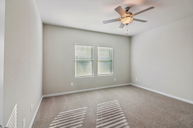 carpeted spare room with ceiling fan