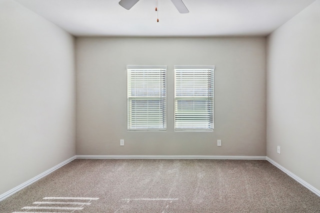 unfurnished room featuring ceiling fan and carpet