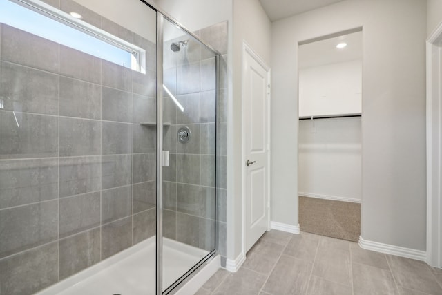 bathroom featuring an enclosed shower and tile patterned floors