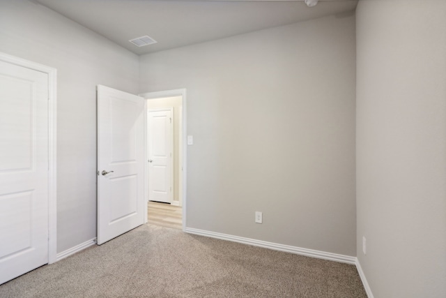 empty room featuring light colored carpet