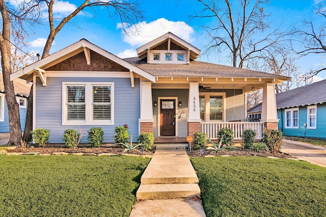 craftsman house with a porch and a front yard