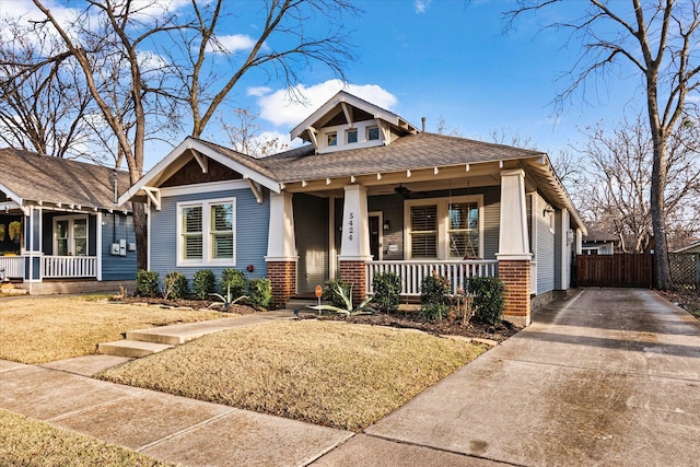 craftsman house with covered porch and a front yard