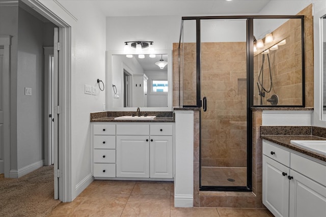 bathroom with vanity, an enclosed shower, and tile patterned floors