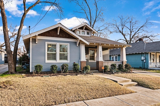 view of front of home with a front lawn and a porch