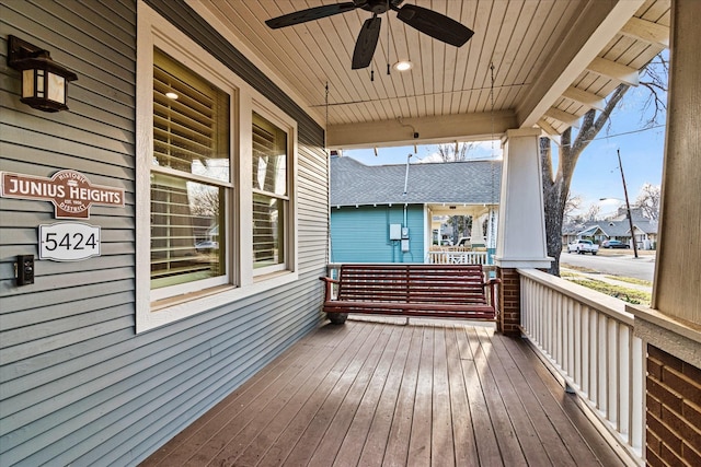 wooden deck featuring ceiling fan and covered porch