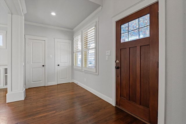 foyer featuring crown molding and dark wood-type flooring