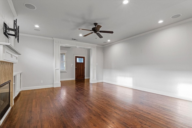 unfurnished living room with crown molding, ceiling fan, dark hardwood / wood-style floors, and a tiled fireplace