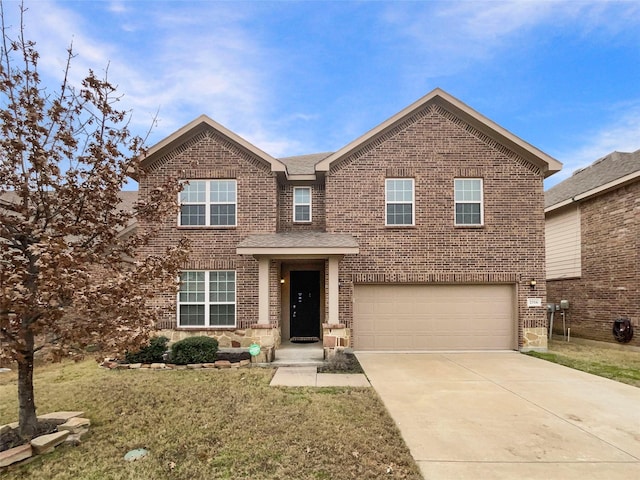 view of front of property featuring a garage and a front lawn