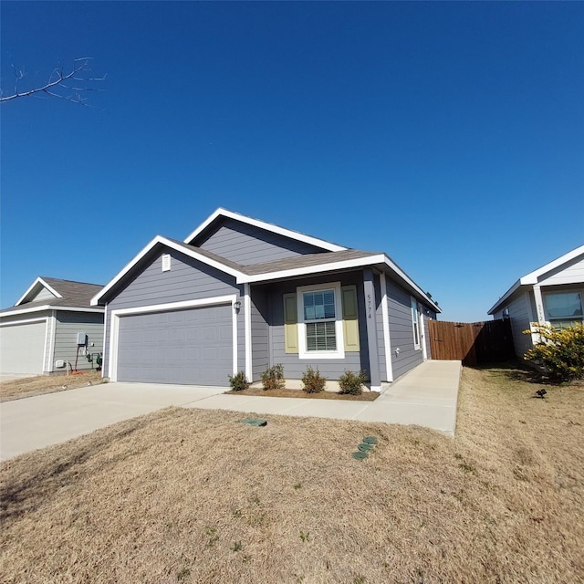 ranch-style home with a garage and a front lawn