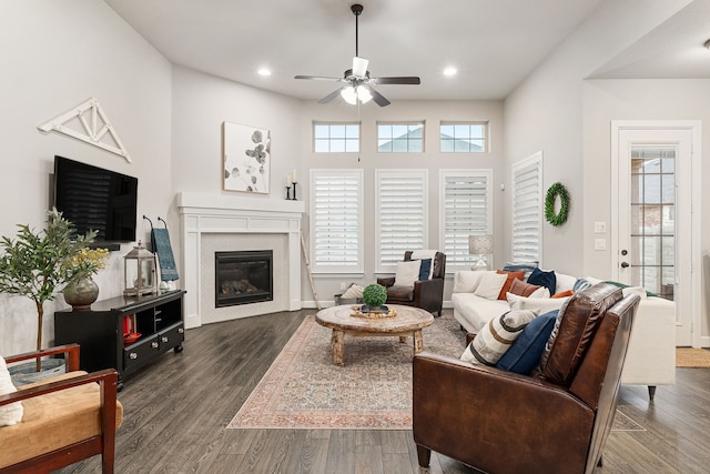 living room with dark hardwood / wood-style flooring and ceiling fan