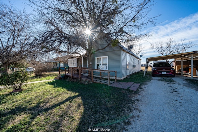 exterior space featuring a front yard and a carport