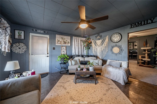 living room with dark parquet floors and ceiling fan