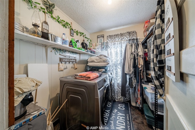 clothes washing area with independent washer and dryer and a textured ceiling