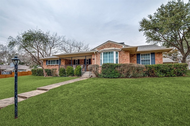 single story home with a front yard and covered porch