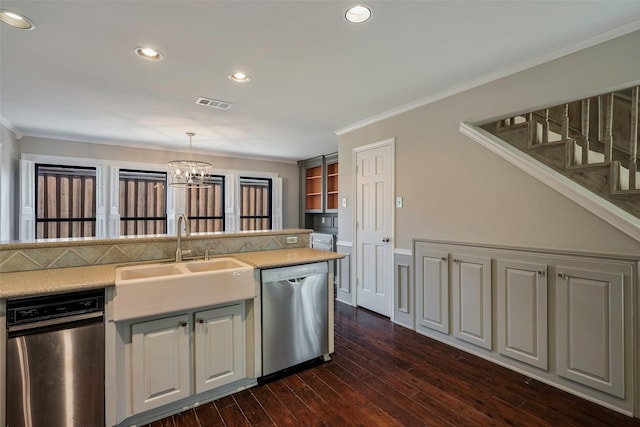 kitchen with dark wood-type flooring, sink, stainless steel dishwasher, ornamental molding, and pendant lighting