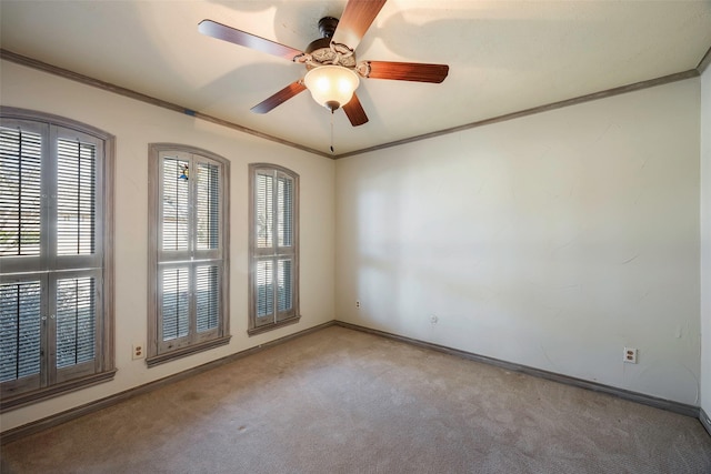 spare room featuring crown molding, carpet, and ceiling fan