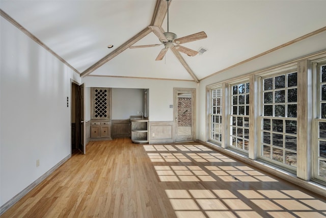 unfurnished sunroom with ceiling fan and lofted ceiling