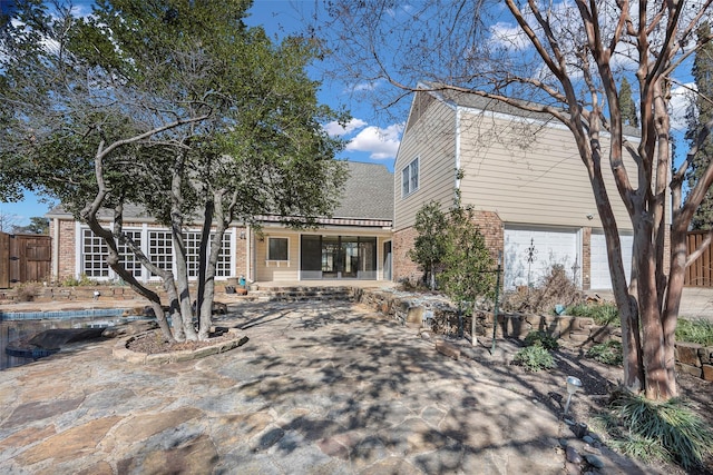 view of front of home featuring a garage and a patio area