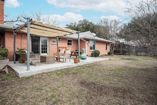 back of house with a pergola, a patio, and a lawn