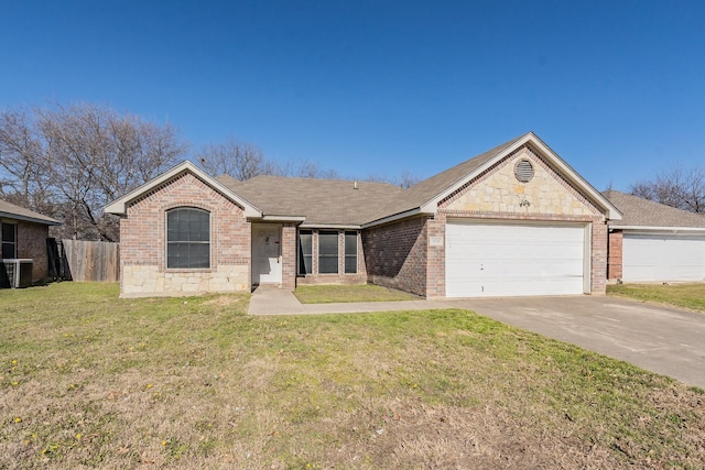 ranch-style home with a garage, central AC unit, and a front yard