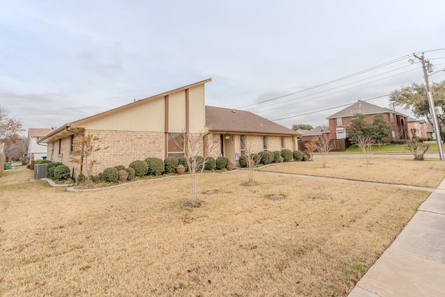 exterior space with central AC unit and a front yard