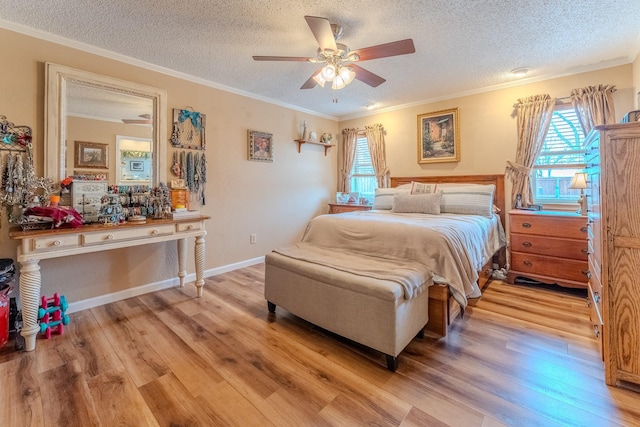 bedroom with ornamental molding, light wood-type flooring, a textured ceiling, and ceiling fan