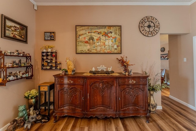 hallway featuring crown molding and hardwood / wood-style floors