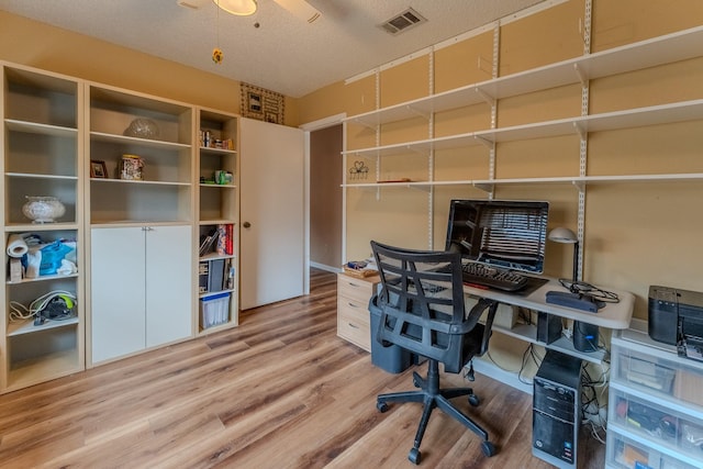 office with hardwood / wood-style floors and a textured ceiling