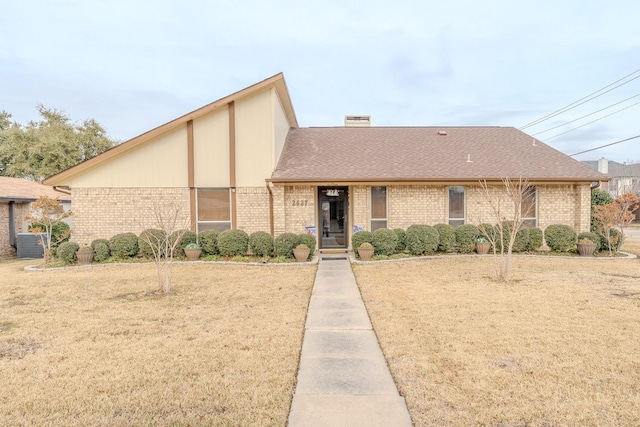 view of front of house with a front yard and central AC unit