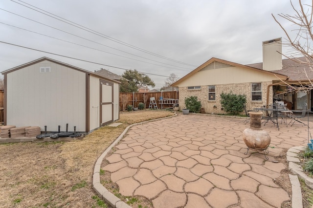 view of patio featuring a shed