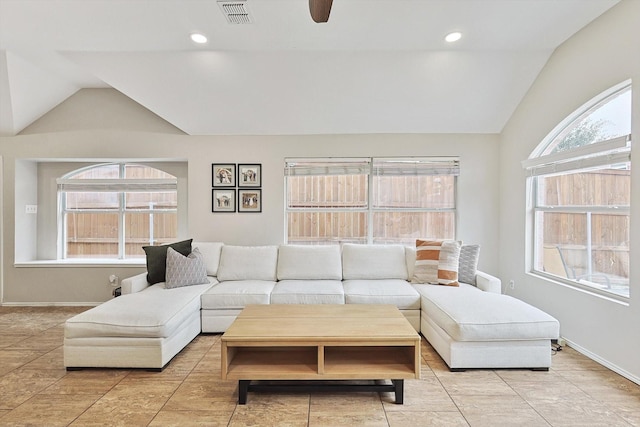 living room featuring ceiling fan, plenty of natural light, and vaulted ceiling