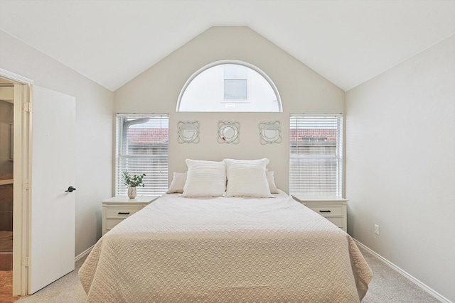 carpeted bedroom featuring lofted ceiling