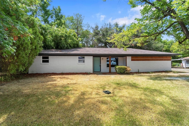 rear view of house with a yard