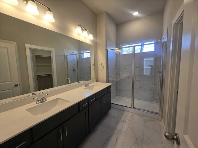 bathroom featuring vanity and a shower with door