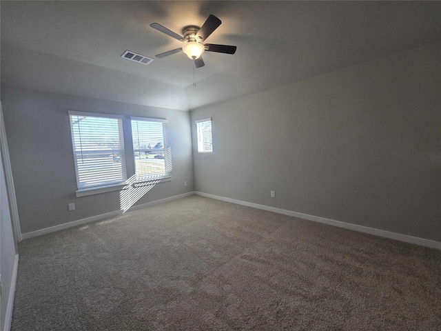 unfurnished room with ceiling fan and carpet