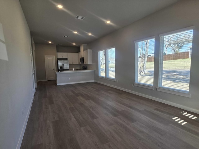 unfurnished living room with dark hardwood / wood-style floors