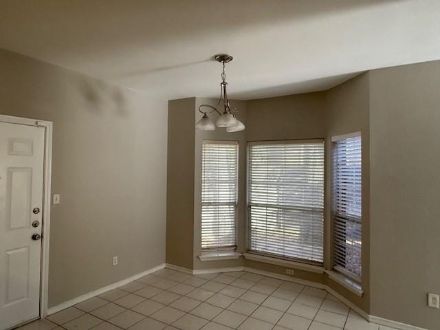 unfurnished dining area featuring light tile patterned flooring