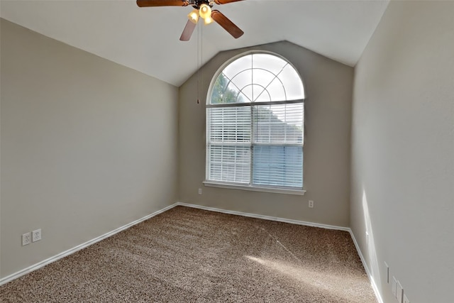 empty room featuring vaulted ceiling, carpet, and ceiling fan