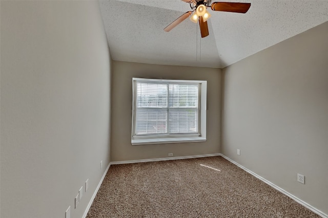 unfurnished room with vaulted ceiling, carpet floors, ceiling fan, and a textured ceiling