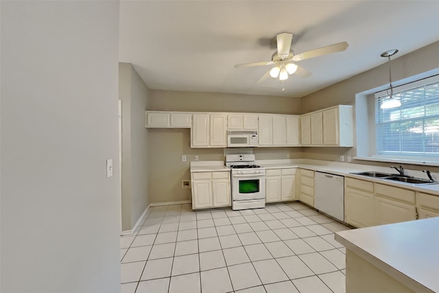 kitchen featuring pendant lighting, sink, white appliances, ceiling fan, and light tile patterned flooring